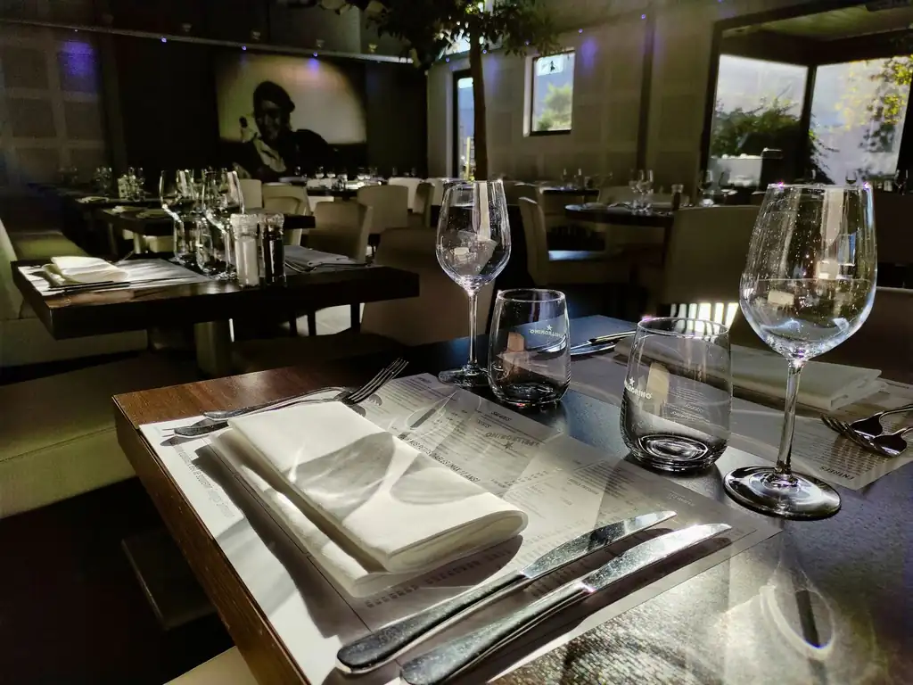 Elegant Quietlidge Works restaurant interior with warm sunlit table settings