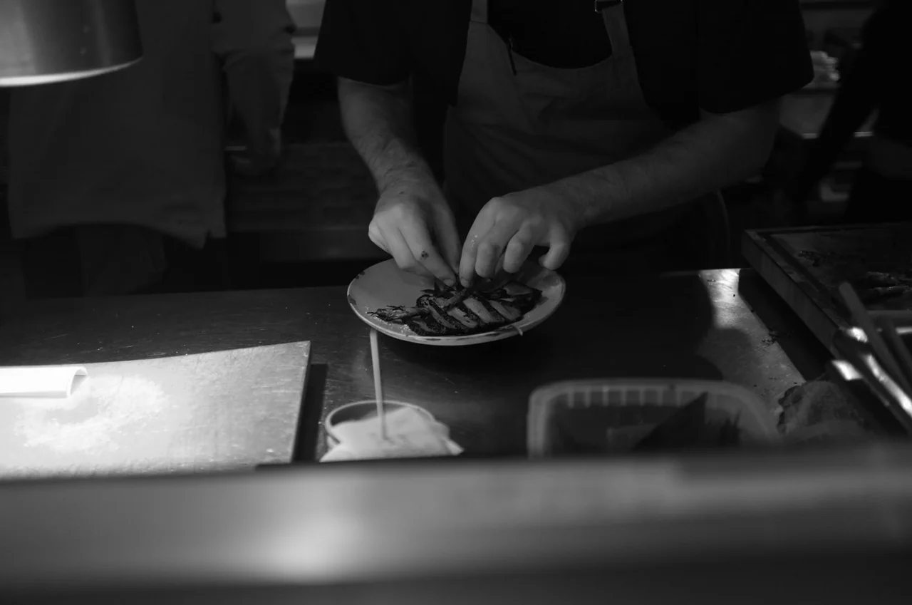 Professional chef meticulously preparing a seasonal dish