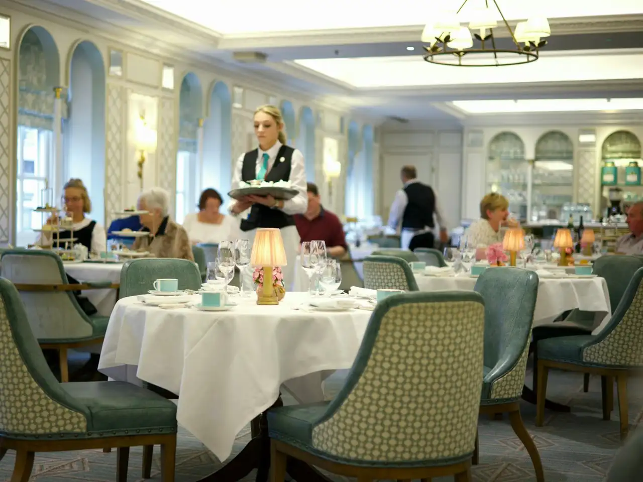 Waitress serving guests in a luxury restaurant