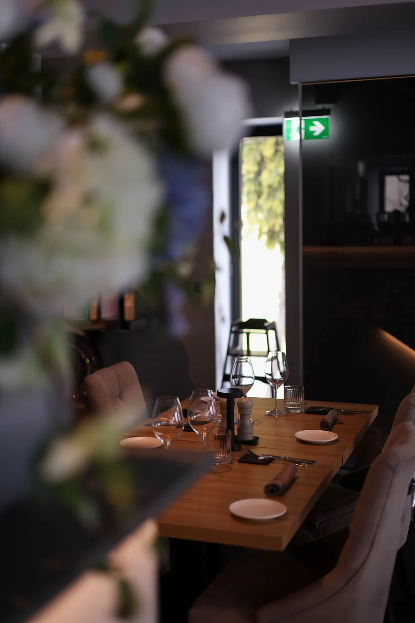 Elegant interior of Quietlidge Works restaurant with warm lighting and refined table settings