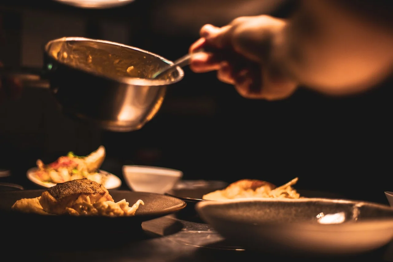 Chef plating a gourmet dish in a professional kitchen