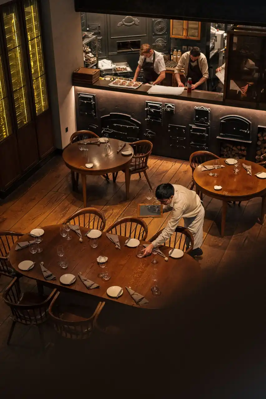 Waitstaff preparing the elegant dining room for an evening private function