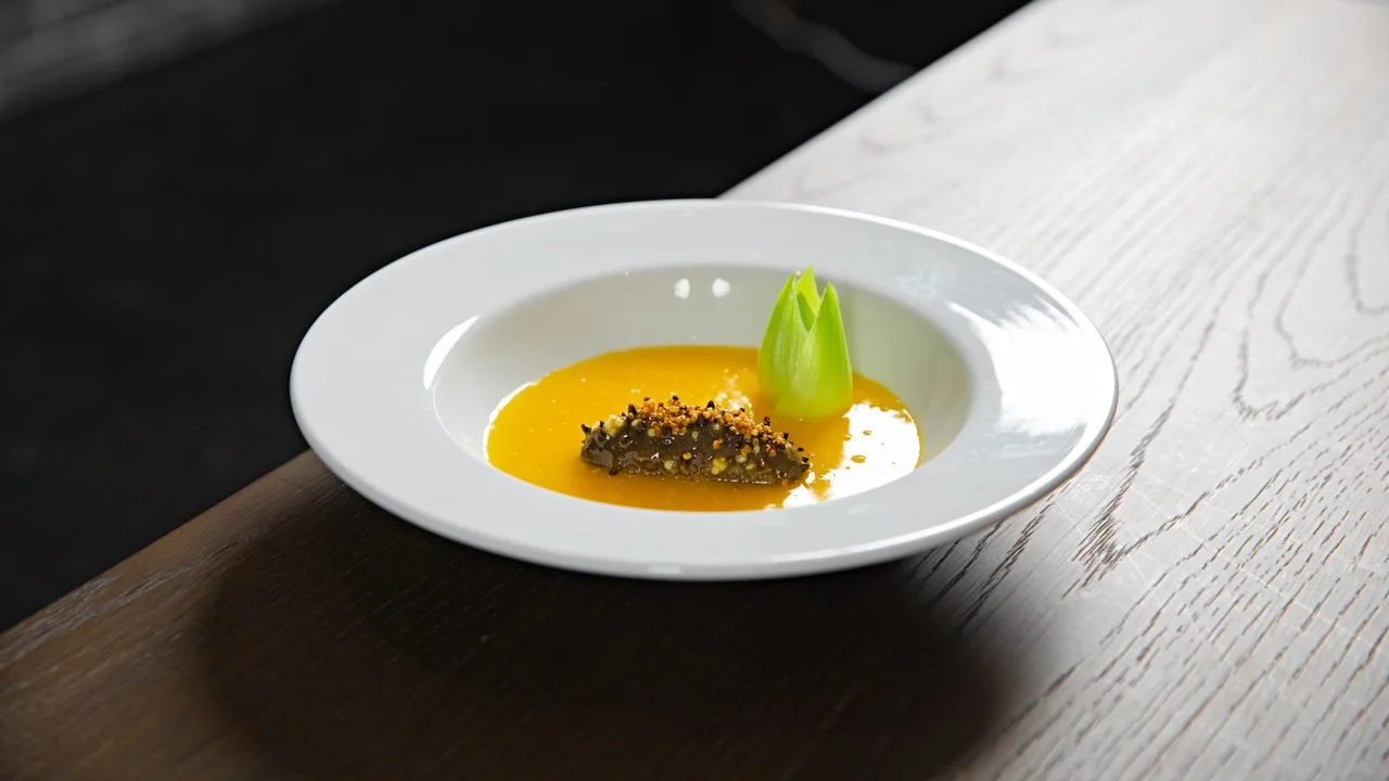 Artful seasonal dessert featuring mango and delicate garnishes served at a birthday gathering